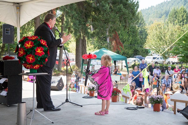 This colourful young lady (dressed as a butterfly) receives a balloon flower for helping Donald with a magic trick, at the Cobble Hill Fair.